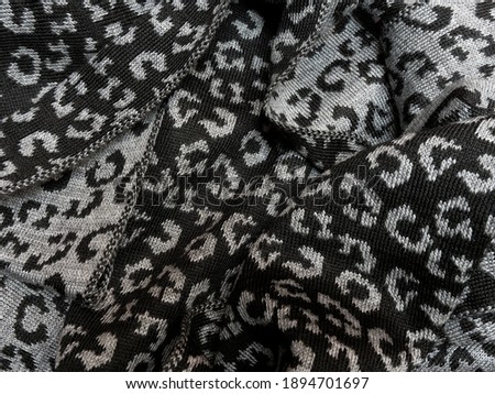 Warm woolen scarf in gray and black colors.