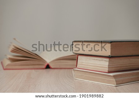 Beautiful vintage ancient books. Pattern background for design. The book on a wooden table and white wall background.