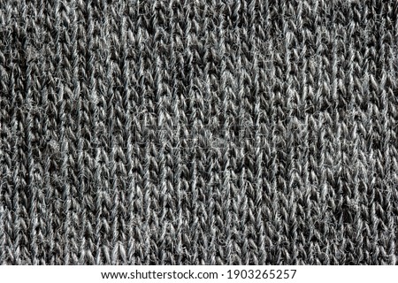 Grey cloth fabric background texture macro top view.