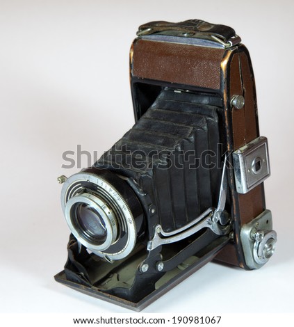 vintage camera with big lens on light background