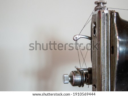 Antique old sewing machine on a white background. tailoring in ancient times