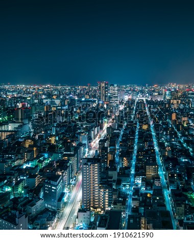 Futuristic Aerial View of City Rooftops at Night in Central Tokyo, Japan