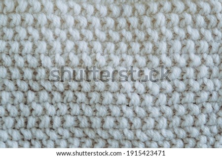 Close up of knitted beige woolen stitches - Soft woolly texture background