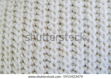 Close up of knitted beige woolen stitches - Soft woolly texture background