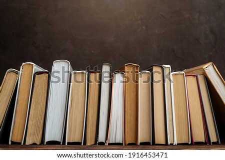  A collection of vintage books on a dark background copy space. vintage books on the shelf