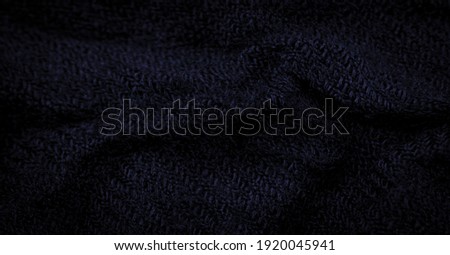 Coarse dark blue woolen fabric. Sheep with long, durable, coarse-fiber wool especially suited to your design. As with various large breeds of lamb. Texture background pattern