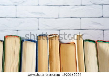 a stack of old hardcover books in close-up, copy space