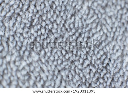 Grey cotton towel or carpet
fluffy texture background. Close up photo.