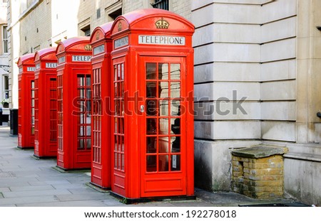 Five traditional old style red phone boxes in London, UK.