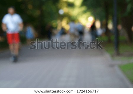 Blurred background. A group of people in a recreation Park.