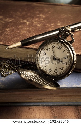 Pocket watch with antique book and pen,vintage color. 