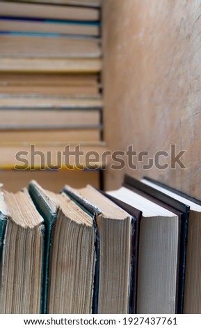 Collection of old books on wooden background. Book in the library. Bookshelf shop. Knowledge publications, literature. Bookish bookstore, bookshop. Booklover.