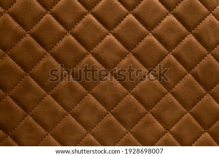 
Brown leather texture. Drawing with rhombuses.
