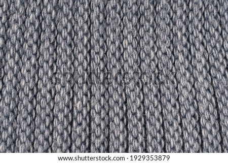 Close-up structure of a knitted product. Scarf, hat or sweater with a chunky knit. Background, texture