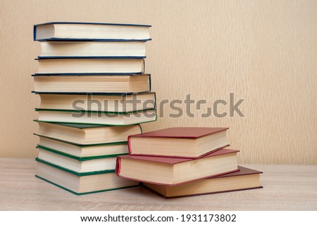 Stack of books on the table on a neutral background