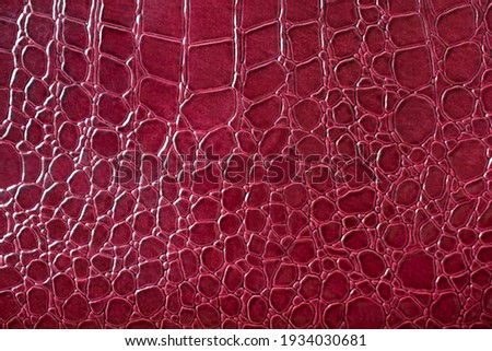 Background from artificial leather under a crocodile burgundy