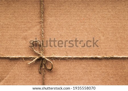 Cardboard box tied with coarse rope
