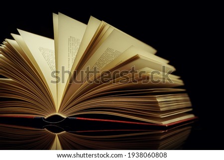 old book against a black background