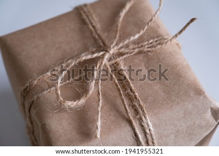 Gift box packaging. Craft paper box. Eco concept. Close-up view. Jute bow.