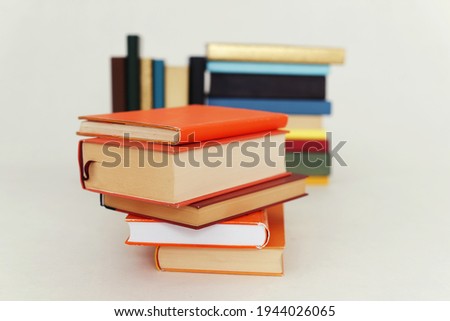 Stack of orange books on white background
