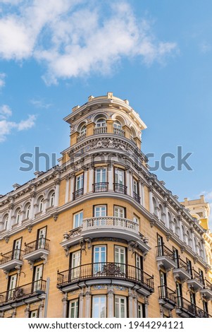 A low-angle shot of a facade of a building on the Gran Via street in Madrid, Spain