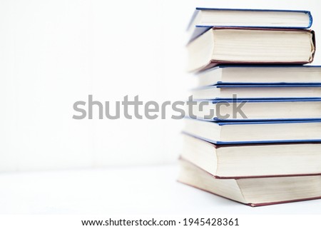 Blurred image stack of books on white background