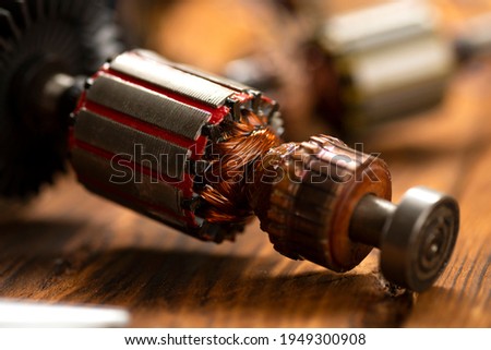 Power tool repair. Details of electrical appliance and repair tools on a wooden table in a repair shop.