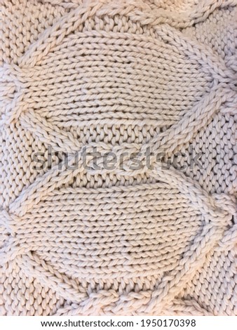 Closeup white warm knitted sweater textile