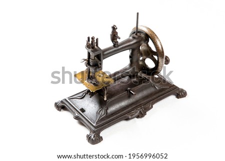 Old sewing machine on a white background