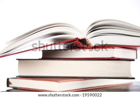 Open book on top of books