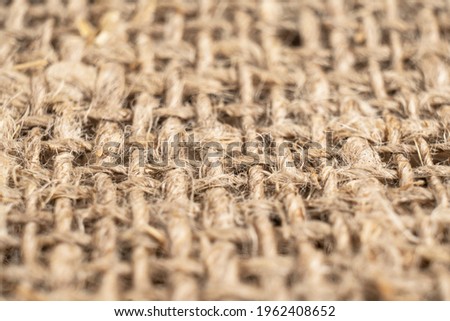 Macro shot yellow linen fabric texture. Linen natural canvas texture with pattern. Rough fabric background texture. Natural linen texture for the background.