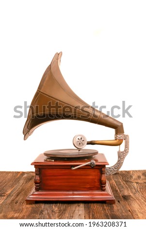 Photos of vintage gramophone on wooden table with white background. Old record or vinyl music player. 