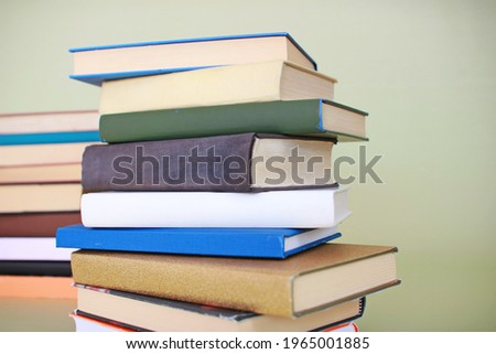 Stack of books on green background