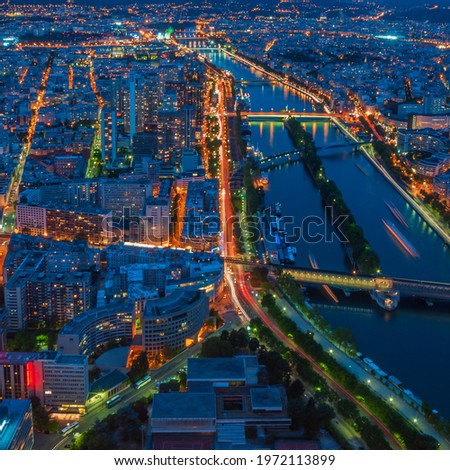 Bird view of Paris night scene with Seine riverside buildings shoot on top of Eiffel tower