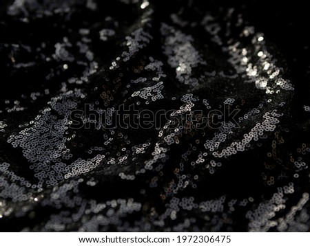 Black background made of black fabric with sequins
