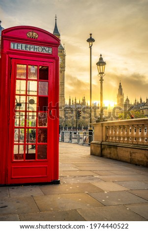 Red telephone booth at sunrise in London. England