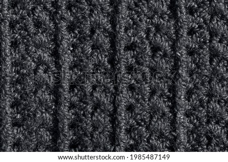 A black knitted texture macro close-up background