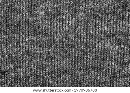 Black fabric texture of natural cotton or linen textile material, warm sweater cloth close up, high resolution background