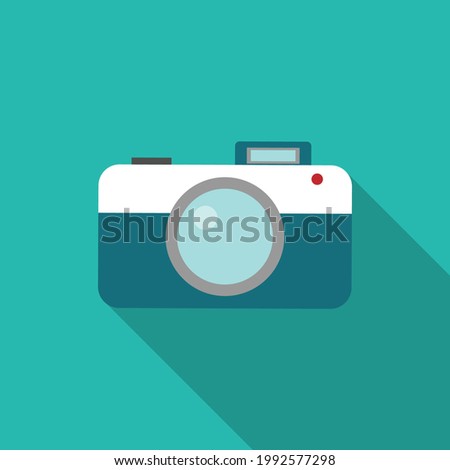 Blue camera on a green background. Illustration of a camera. Pictures.