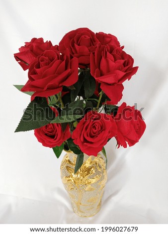 artificial red roses in a vase