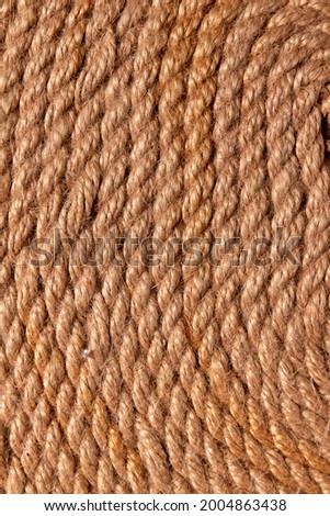 Close up view of twisting brown hemp rope pattern.