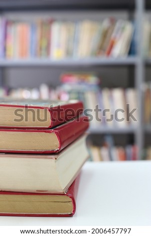 Stack of red books on the table in library