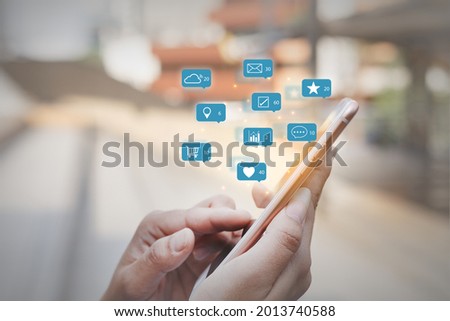 close up finger pointing at screen of smartphone with notification social media icons, internet digital marketing concept.