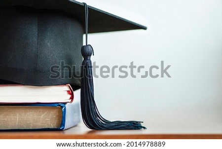 Graduates are celebrating graduation. book and a hat on the table with empty copy space, Congratulation, Graduation day concept 