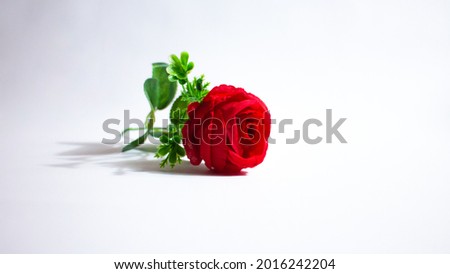 Fake red roses made of plastic and cloth on a white background