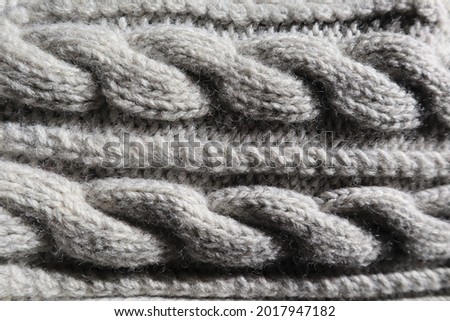 Close up of grey wool cable knit texture and pattern