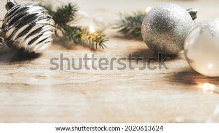 Christmas decorations, light, balls and branches on a white wooden background for the concept of holidays and festival celebrations