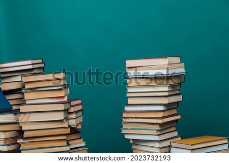 stacks of books for teaching knowledge of the university library green background