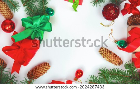 Christmas background with red Christmas decorations on a white background with a Christmas tree. Merry Christmas greeting card, banner. Winter holidays theme. Happy new year concept.