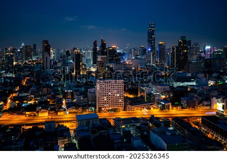 Night cityscape and high-rise buildings in metropolis city center . Downtown business district in panoramic view .